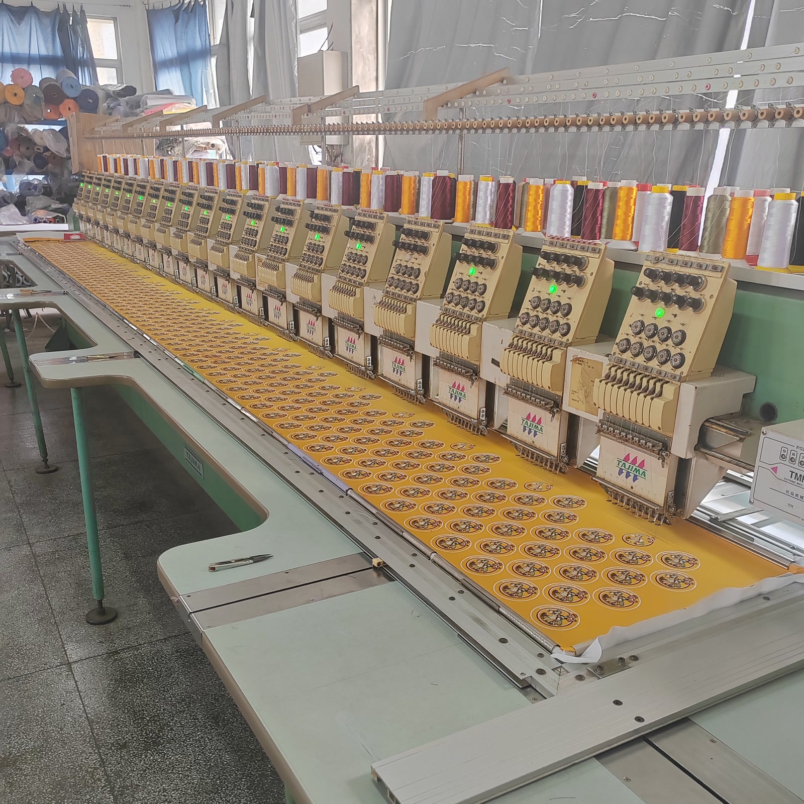Tajima multi-head embroidery machine working on a production run at Duopei
